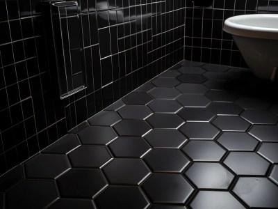 Black Hexagon Tiles On The Floor Of A Bathroom