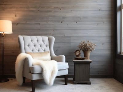 Living Room With A Grey Wall, White Couch, And Chair With A White Sheepskin Throw