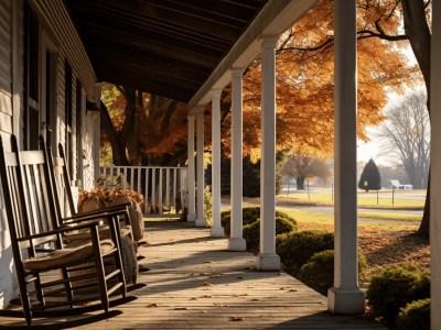 Porch Lined With Rocking Chairs In A Fall Scene