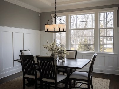 Remodeled Dining Room With Chandelier And White Paneled Walls