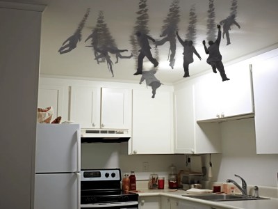 Small Kitchen With Various Silhouettes Of People Swimming On A White Ceiling