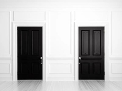 Two Black Doors Next To White Walls