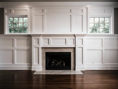 White Fireplace In A Room With Hardwood Flooring