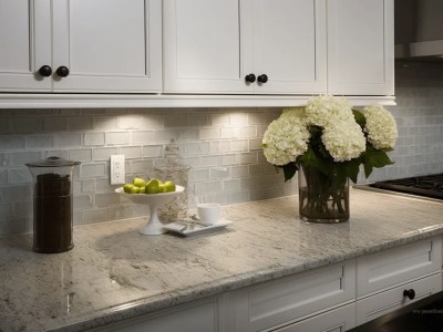 White Tile On The Backsplash Of A Kitchen