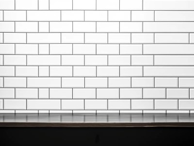 White Tile Wall W/ Black Cabinet Background In Black And White Photo