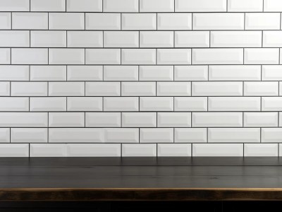 White Tiled Wall Is Shown Over A Wooden Table