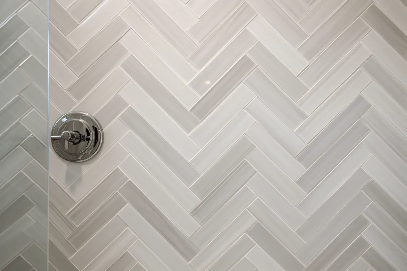 Grey herringbone tile pattern in white with black accent, intense close-ups, contemporary glass, light white and dark brown, light indigo and white, polished craftsmanship, soft focal points, natural lighting