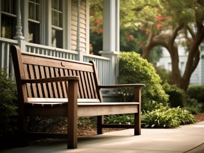 Wooden Bench Sitting On The Porch Outside Of A House